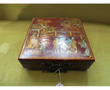 A lacquer box with Oriental design containing a miniature chess set 