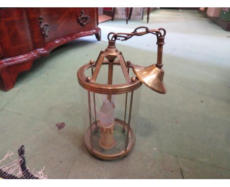 A circular brass hanging hall light 