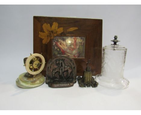 A pair of cast metal bookends, a glass watch dome, a watch holder, ships wheel nutcracker and marquetry picture frame with mo