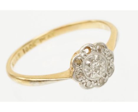 18ct gold and platinum daisy ring. The ring set with diamond accent stones to the head. Marked 18ct &amp; plat. Size P. 