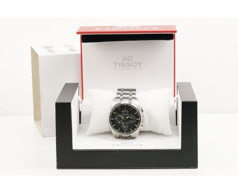 Tissot chronograph automatic wrist watch having a round black face with three subsidiary dials, silver baton markers to the c