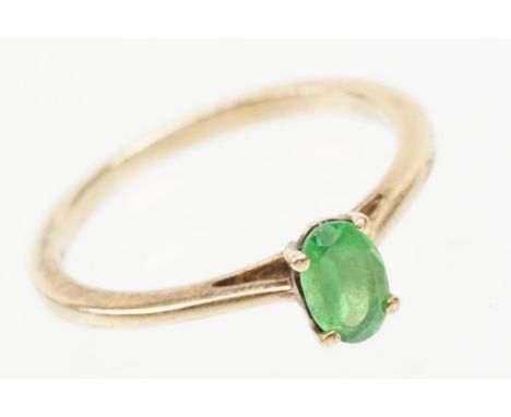 9ct gold Tsavorite garnet ring. The ring being set with an oval cut tsavorite garnet in a four prong setting on a plain band.