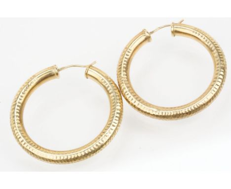 Pair of 9ct gold hollow hoop earrings with hinged posts. Hallmarked 375 to posts. Measures 4cm diameter. 