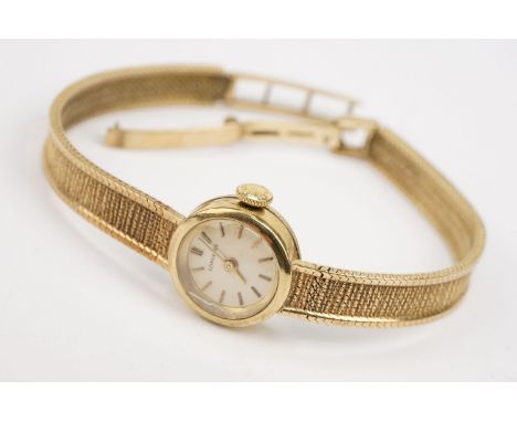 1970s 9ct gold Longines cocktail watch having a round face with baton markers to the chapter ring on a mesh bracelet strap. H
