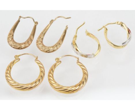 Three pairs of hoop earrings to include a pair of 9ct  two tone cross over earrings (marked 375 to post), a pair of 9ct twist