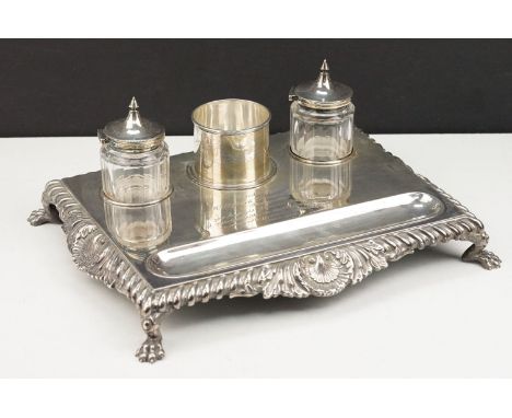 Early 20th Century silver hallmarked ink stand having a silver base with gadrooned borders raised on lions paw feet, with a p