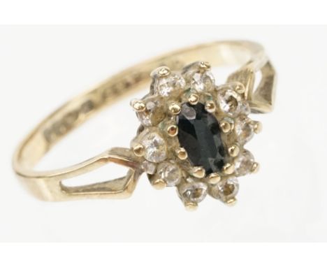 9ct gold sapphire and cz cluster ring having a marquise cut sapphire to centre surrounded by CZ's with pierced shoulders. Hal