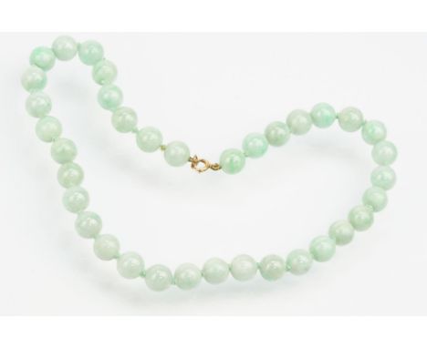 Jade beaded necklace threaded with green jadeite spherical beads with a 9ct gold clasp. Measures 15 inches. Beads approx 9mm 
