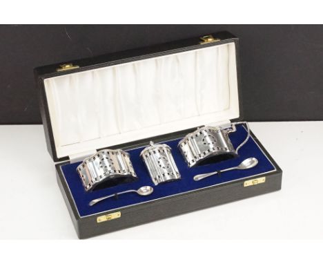 20th Century silver cruet including mustard pot, table salt and pepper pot all with blue glass liners, with pierced motifs to