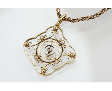 Edwardian 15ct gold open work pendant being set with a diamond to centre with seed pearls surrounding it (marked 15ct to vers