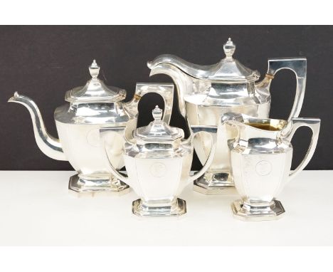 Chinese silver tea service comprising teapot, hot water pot, cream jug and sugar bowl. All of hammer canted design. Marked Tu
