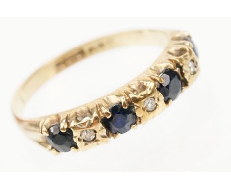 9ct gold sapphire and diamond ring. The ring being set with four round cut sapphires with diamond accent stones. Hallmarked B