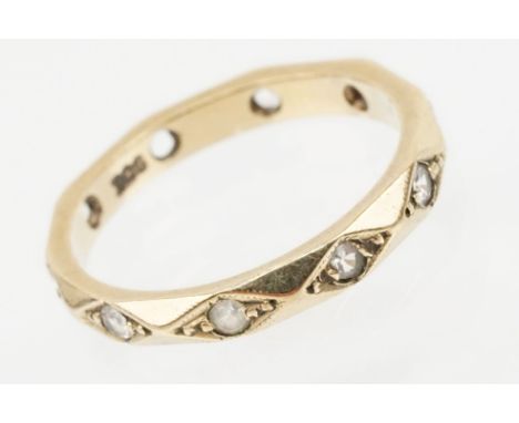 9ct gold and white stone eternity ring set with round cut white stones in diamond shaped settings. Marked 9ct. Size M. Two st