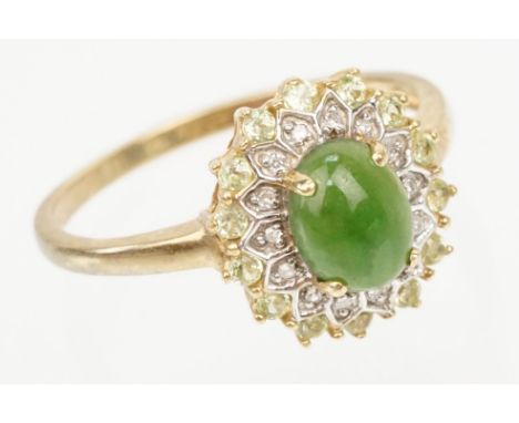9ct gold jade and diamond cluster ring. The ring being set with an oval jade cabochon to centre with a halo of diamond and gr