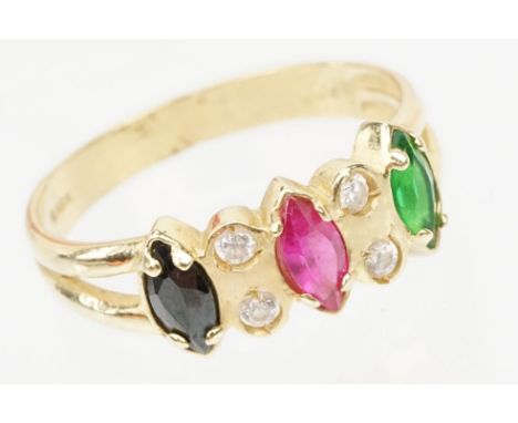 15ct gold gemstone set ring. The ring set with three marquise cut coloured stones to the head having a synthetic ruby to cent