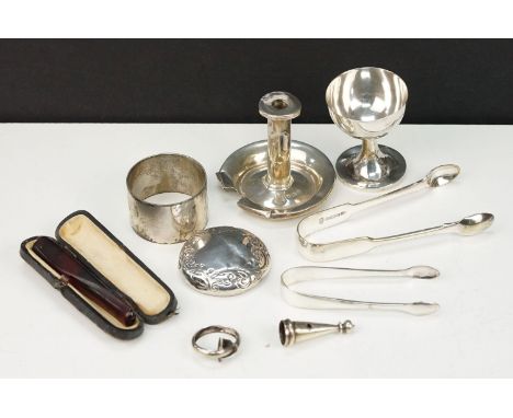 Collection of silver items to include an egg cup, small chamberstick, napkin ring, and jar lid. All hallmarked 925. Candlesti