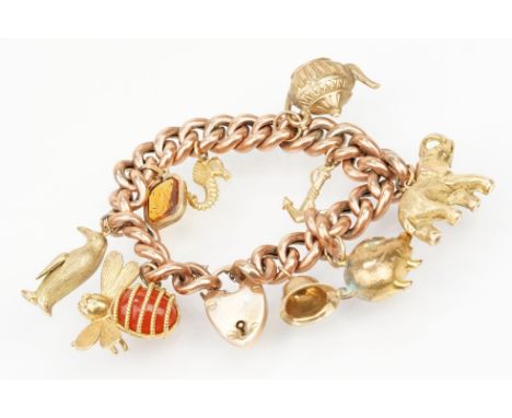 9ct gold charm bracelet having a rose gold bracelet chain with heart padlock clasp (marked 9ct to clasp) having eight 9ct gol