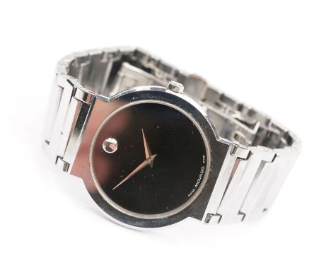 Movado stainless steel wristwatch having a round black face with silver dot to twelve, mounted to a bracelet strap. Case meas