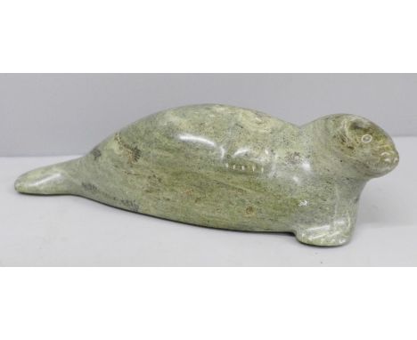 A Canadian Eskimo Art (signed Bobert Uppik) carved stone model seal, 19cm 