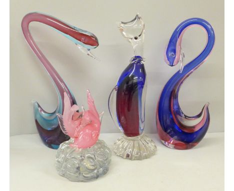 A Murano glass model of a cat, two swans, one a/f and a fish paperweight 