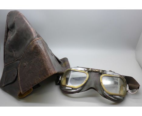 A leather motorcycle riding cap and a pair of goggles 