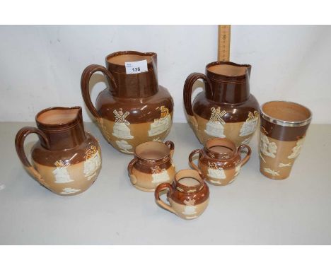 A group of Doulton stone ware jugs and cruet items with sprigged harvest and hunting scene decorations