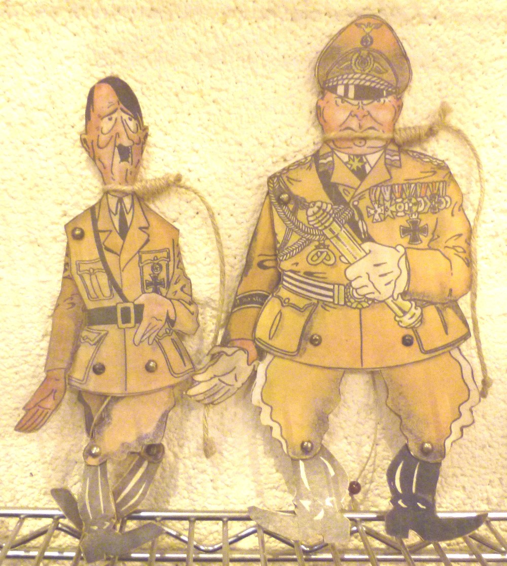 Two cardboard puppets, Hitler and Goebbels with string nooses