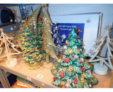 Shelf of Christmas decorations including snow ball curtain lights 