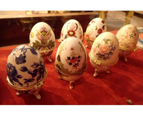 Collection of seven ceramic egg shaped jewellery caskets 