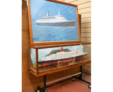 Glass encased model ship 'Cunard Queen Elizabeth II' and a framed print of the QEII