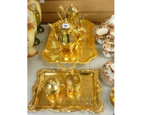 Gold plated four piece tea service on a similar tray and another large two handled gold plated tray on supports