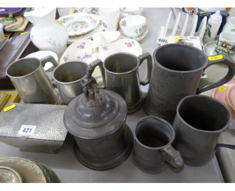 Beaten pewter lidded box, pewter tankards and a pewter tea caddy
