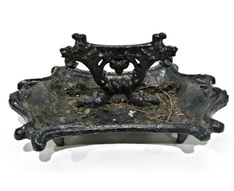 Cast iron black painted boot scraper and a small quantity of textiles, 40cm wide
