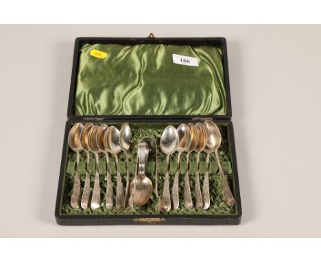 A cased set of twelve hallmarked Silver tea spoons and matching sugar tongs with a silver caddy spoon