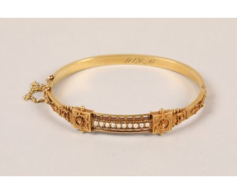 Ladies 15ct yellow gold and seed pearl Etruscan style bangle; gross weight 8.3g Condition report18cm circumference, 6 * 5.1cm