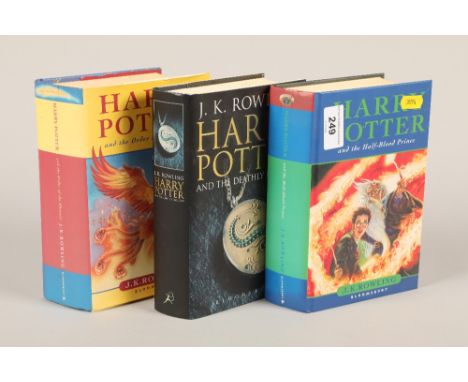 Three first edition Harry Potter books, Harry Potter and the half blood Prince, Harry Potter and the Deathly Harrows, and Har