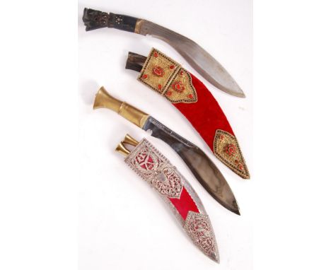 Two 20th century middle eastern kukri knives to include; A usual formed wooden carved and brass collared kukri knife with cru