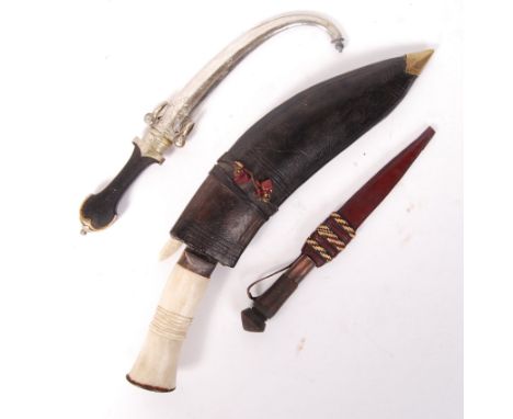 A collection of&nbsp; vintage Middle Eastern and African knives to include; A bone handled Kukri knife with blade detailing w