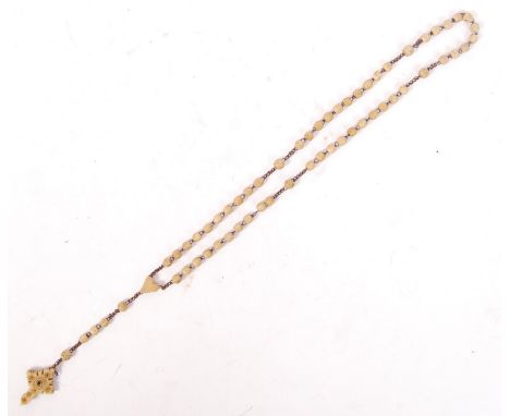 A WWI First World War era carved bone stanhope rosary bead necklace. Neatly carved, with crucifix to end. The stanhope showin