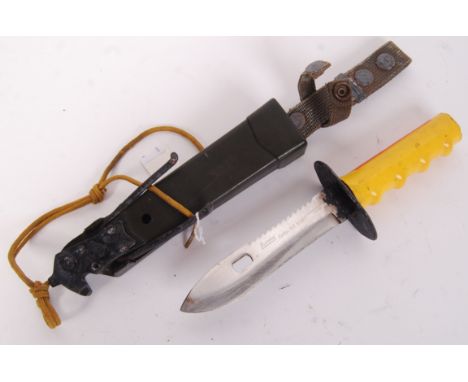 A 20th century John Nelson Cooper American survival knife, with yellow rubber ' John Cooper ' handle within the original scab