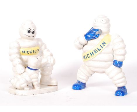Two cast iron Michelin Tyres ' Bibendum ' figural mascots. The first depicting Bibendum and dog, the other depicting Bibendum