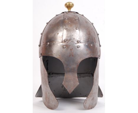 A good 20th century reproduction 18th century style suit of armour Knight's helmet. Brass finial to top, with steel plate con