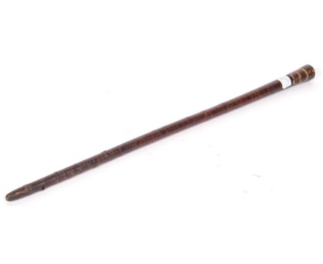 A WWI First World War period antique vintage swagger stick with horn adornment to pommel and tip having a wooden disk shaft. 