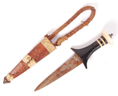 A late 19th century Sudanese arm dagger having short tapering steel blade with a horned and ivory banded handle with a wide i