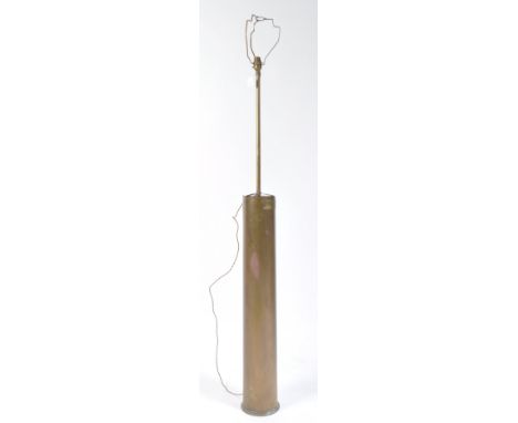 A vintage 1930's large brass artillery shell later converted into a standard lamp. Brass elongated shaft, with shade fitment 