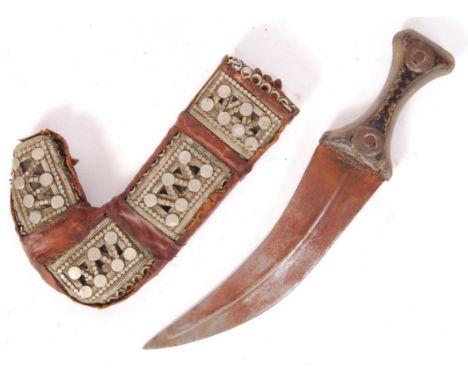 A 20th century small proportioned Arabian Jambiya Khanjar dagger and scabbard having a wooden handle ridged wide blade and le