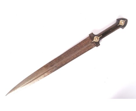 An antique 19th century Islamic / Malaysian ceremonial dagger. Believed horn handled, with a beautifully decorated blade, wit
