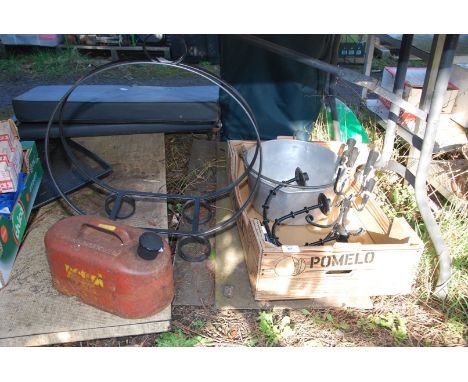 A jam pan, candelabra, petrol can and wrought iron log store.