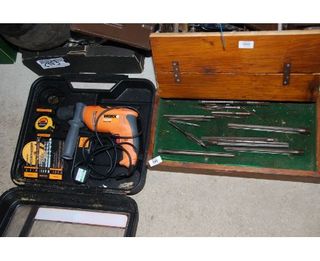 A "Worx" hammer drill and a box of reamers.