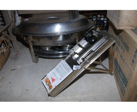 A stainless steel mandolin/food slicer and a food warmer.